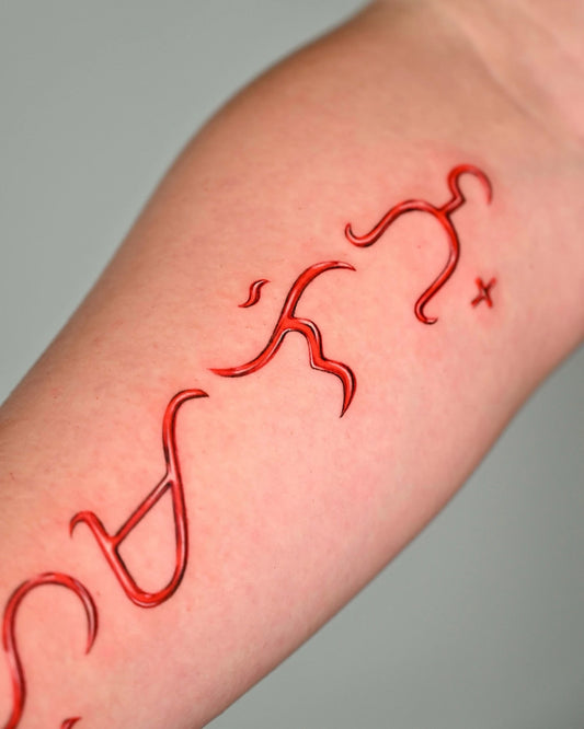 abstract red pattern arm tattoo
