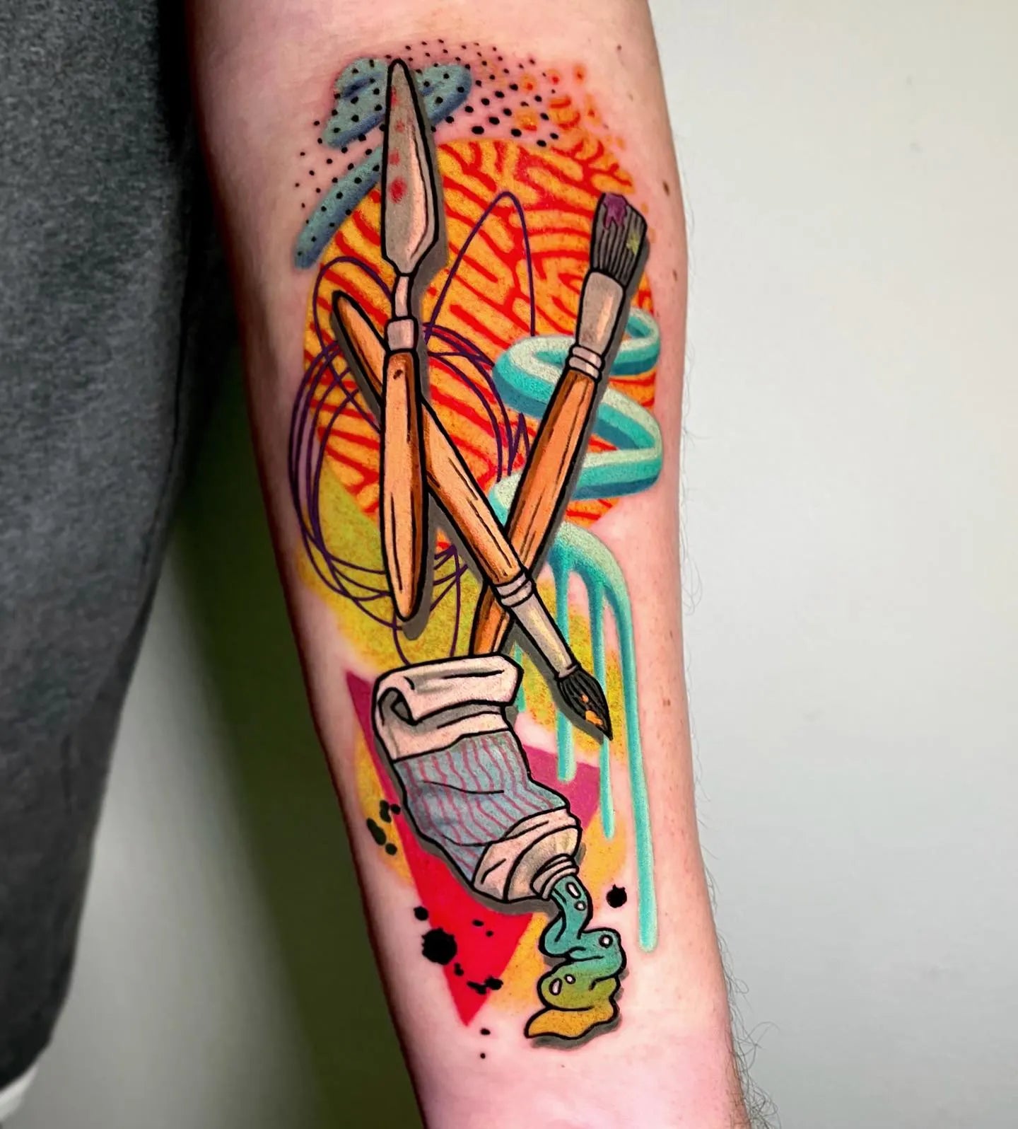 colorful painting tools forearm tattoo