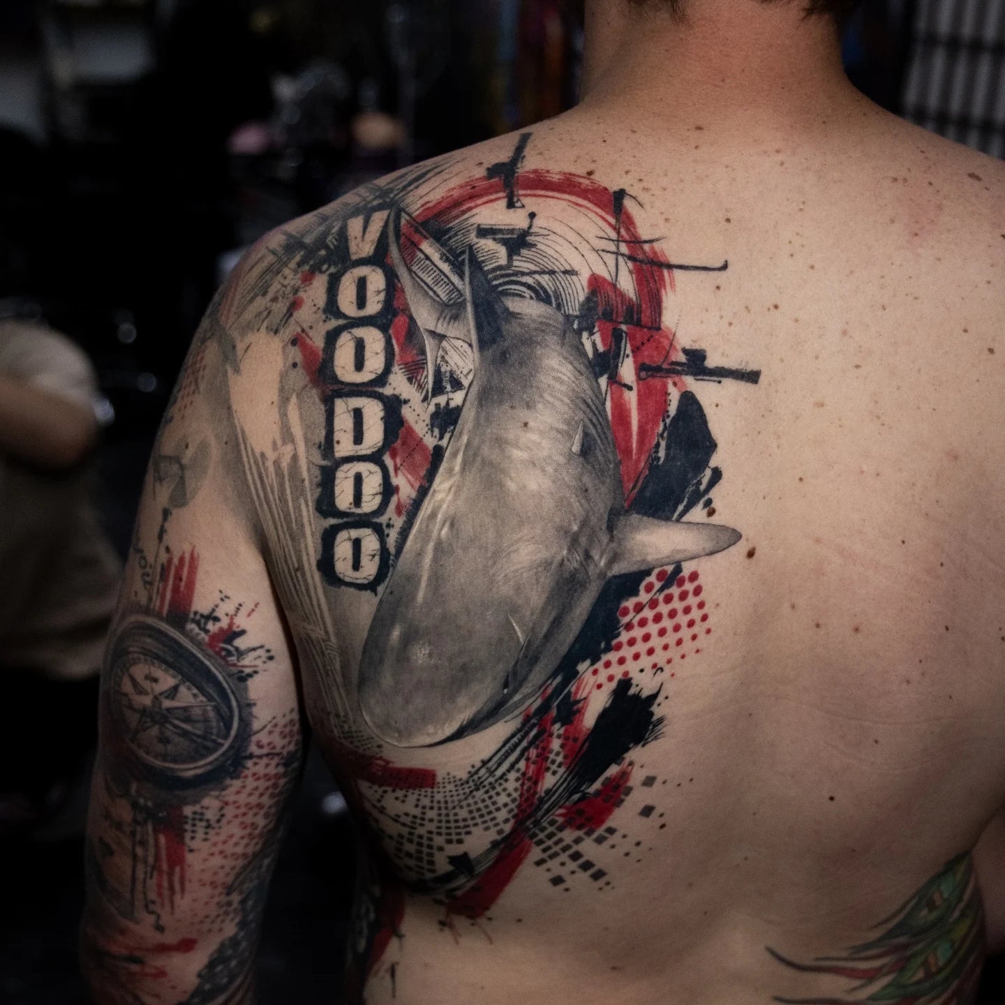 trash polka voodoo shark tattoo on man shoulder back