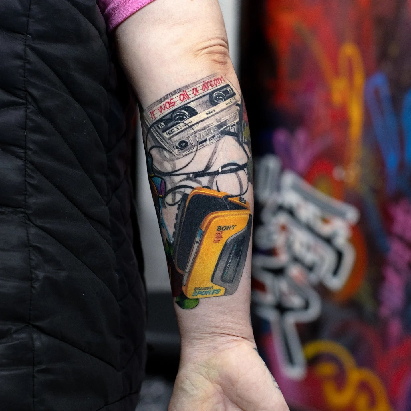 color realism tattoo of a vintage cassette player on forearm