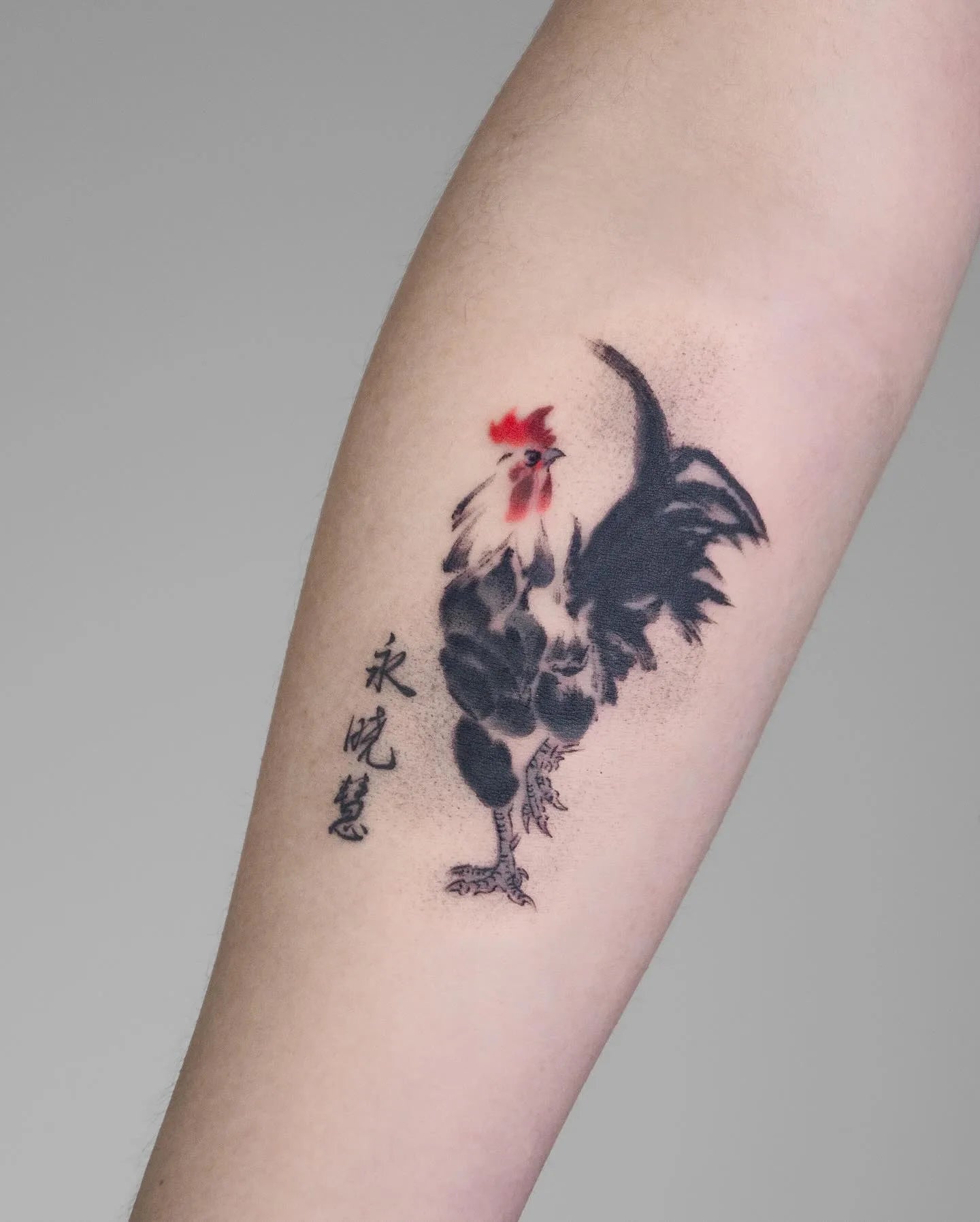 brush stroke style rooster tattoo with chinese name on forearm
