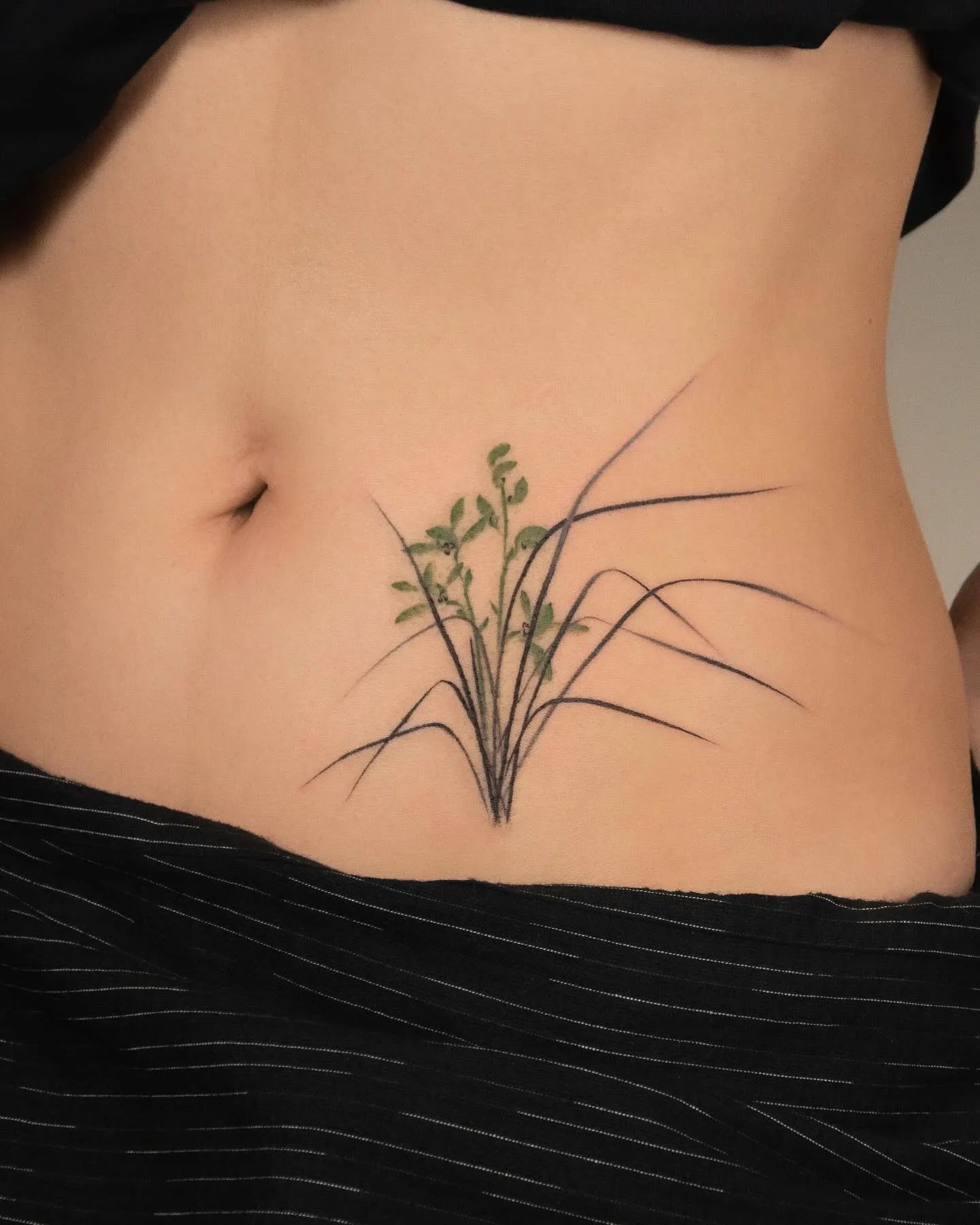 chinese Orchid tattoo on woman stomach