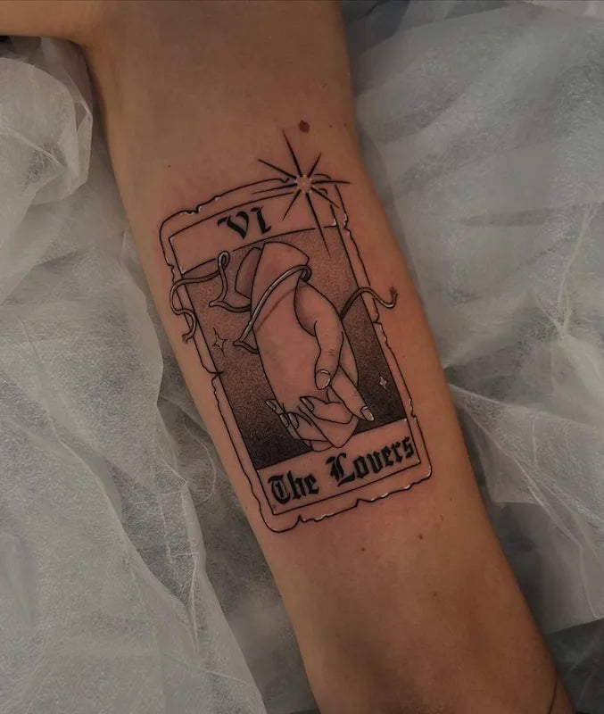 Tattoo of 'The Lovers' tarot card on a person's arm