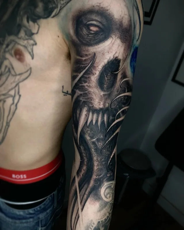 black and grey darkwork realism tattoo on man arm
