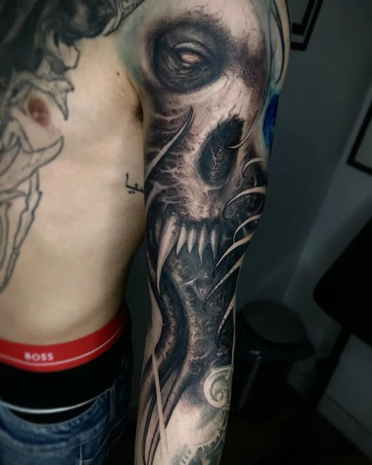 black and grey darkwork realism tattoo on man arm