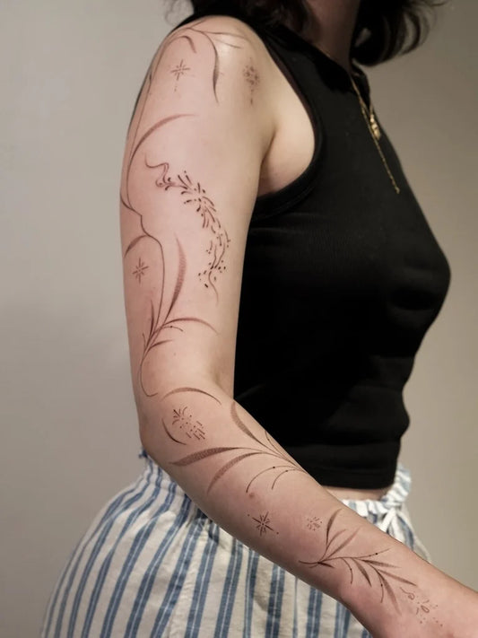 fine line ornamental woman full arm tattoo