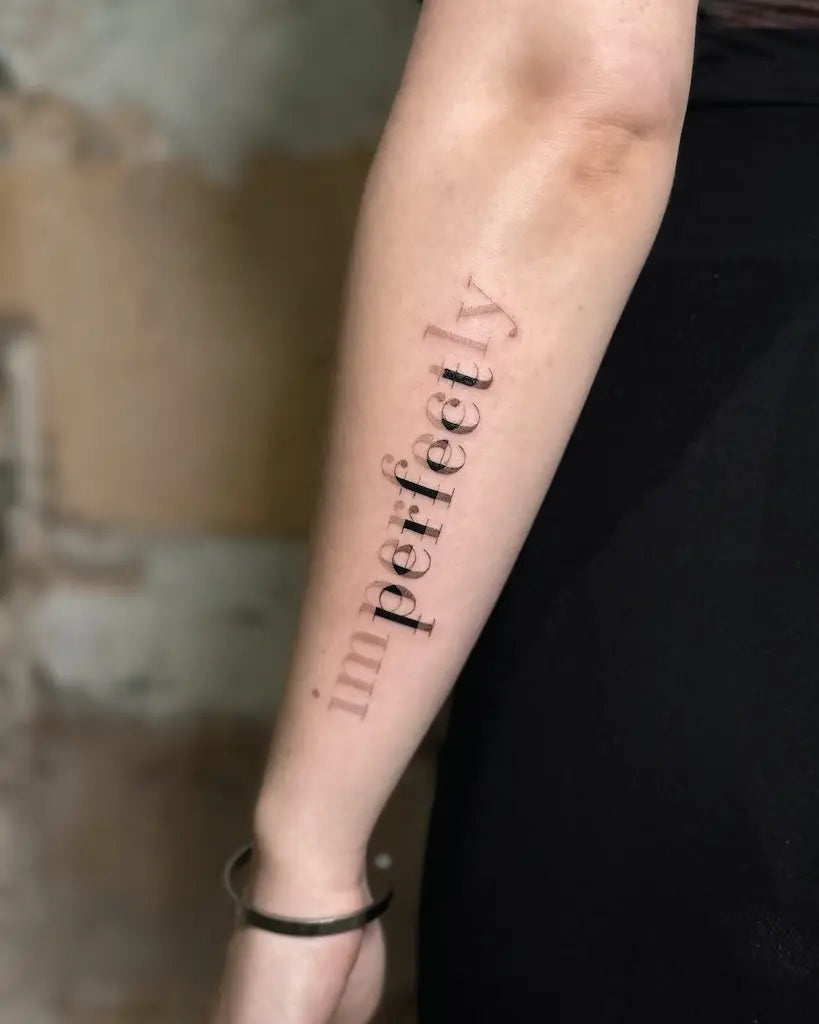 blurry font perfect lettering forearm tattoo