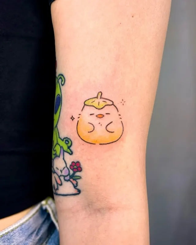 cute duck from Spirited Away Ootori sama hand poke minimalist tattoo on woman bicep