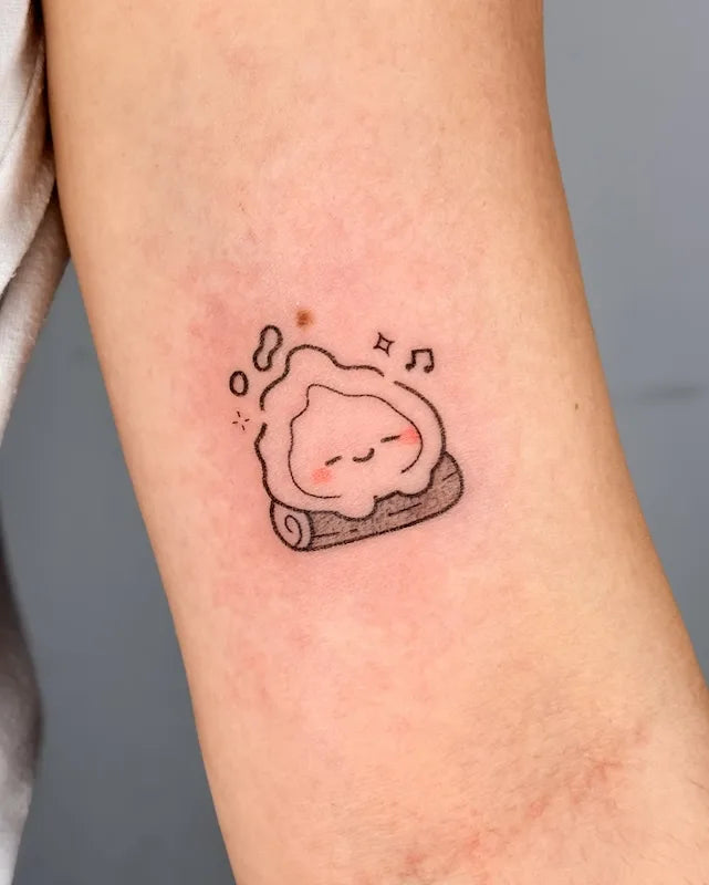 cute chonky baby Calcifer on log outline hand poke minimalist tattoo