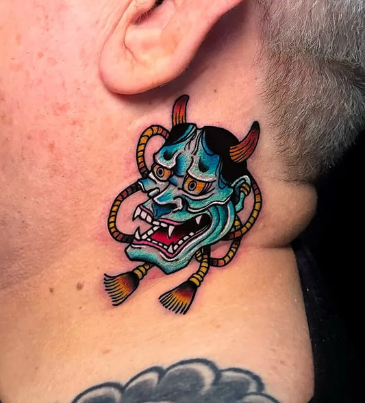 blue colorful japanese hannya mask tattoo behind the ear