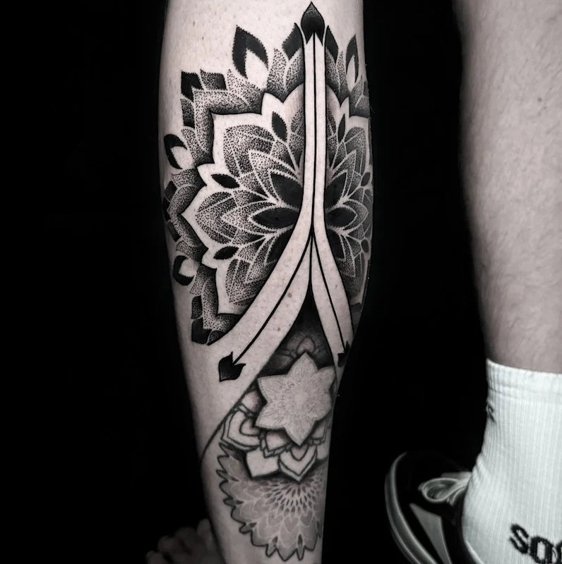 geometric dotwork mandala tattoo on man calf