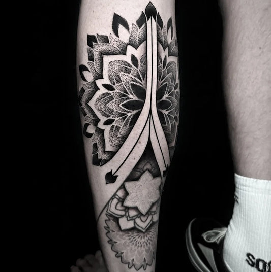 geometric dotwork mandala tattoo on man calf