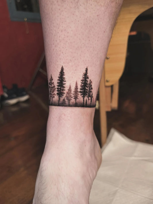 pine trees wrap tattoo on ankle