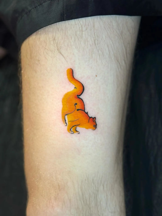 minimalist orange cat tattoo
