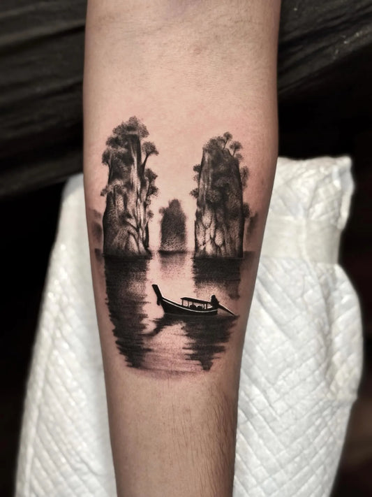 black watercolor lake trees scene tattoo