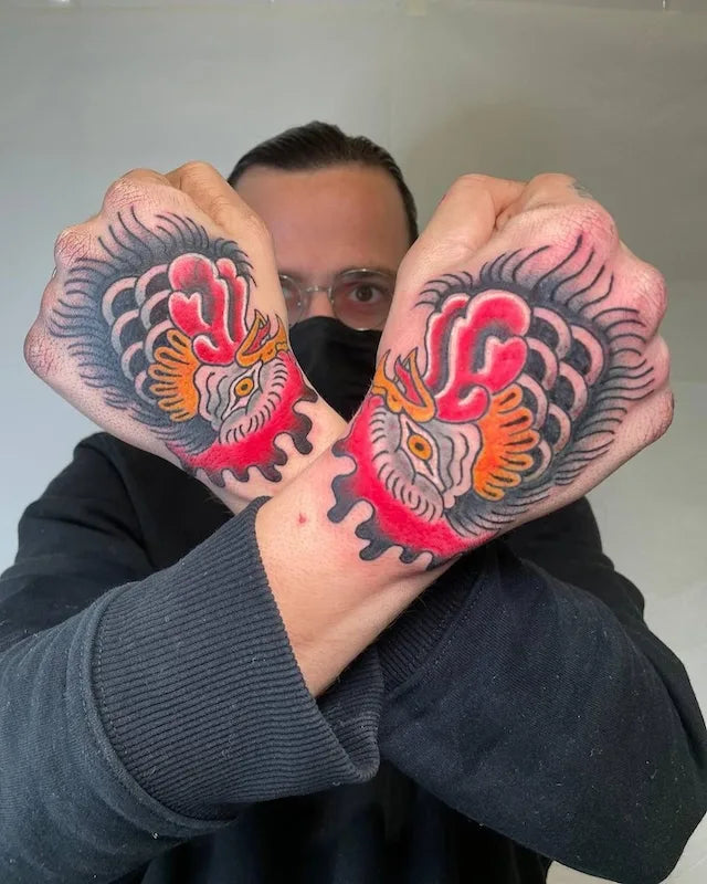 symmetrical japanese tattoo on man hands