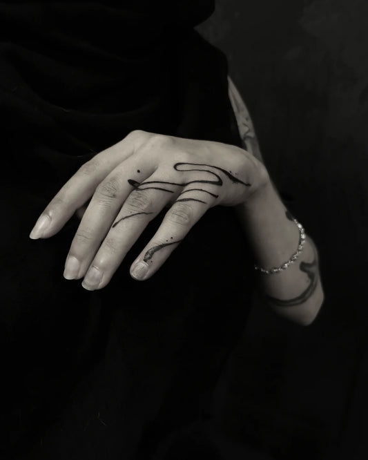 blackwork abstract line tattoo on woman hand