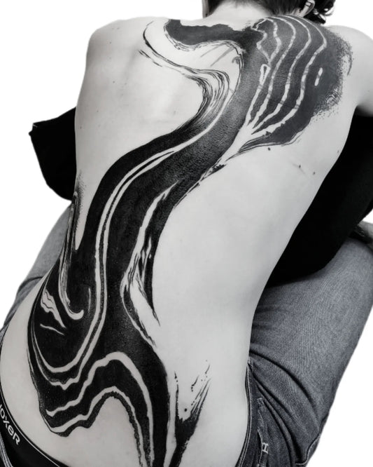 blackwork abstract black watercolor brush stroke tattoo on woman full back