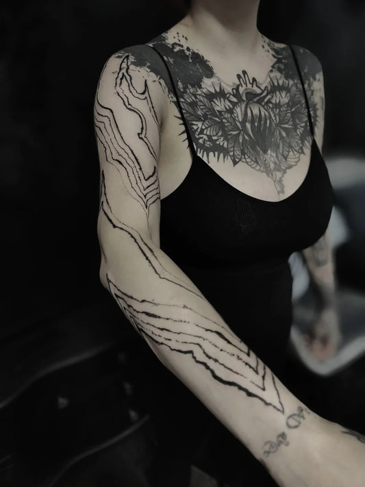blackwork black abstract lines tattoo on woman full arm