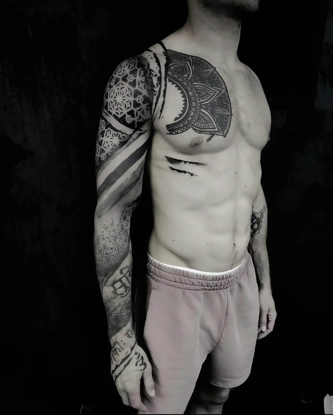 blackwork geometric tattoo on man full arm sleeve