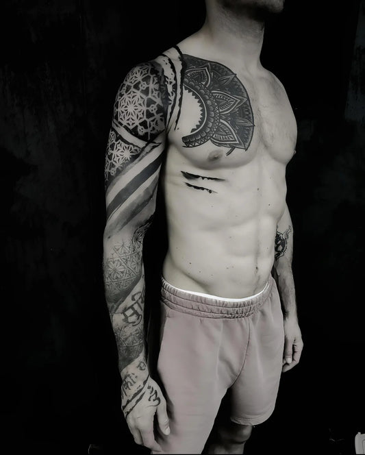 blackwork geometric tattoo on man full arm sleeve