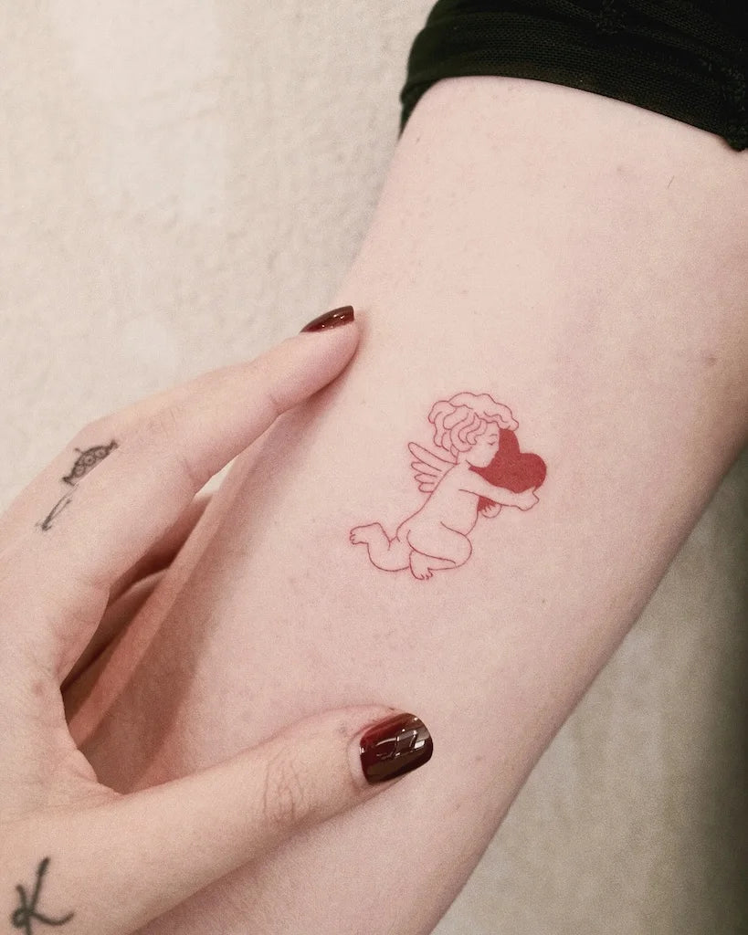 minimalist red cherub angel cupid holding heart outline tattoo