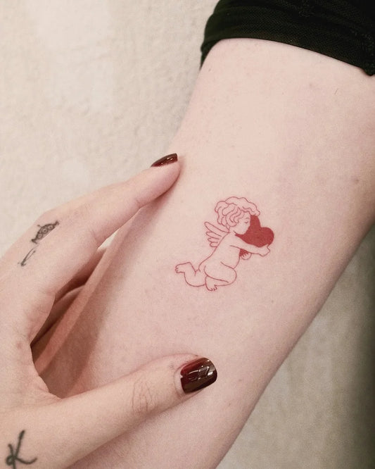 minimalist red cherub angel cupid holding heart outline tattoo