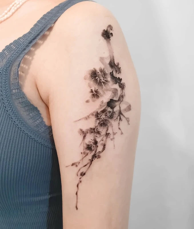 black watercolor oriental floral tattoo on woman upper arm
