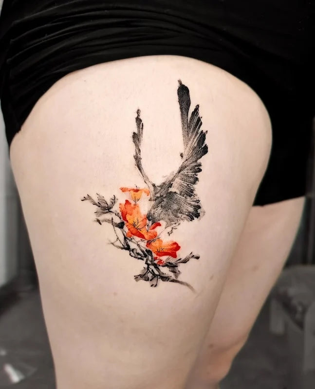 oriental painting bird and flower tattoo on woman thigh