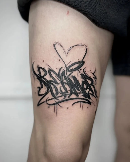 black calligraphy sketchy lettering on thigh