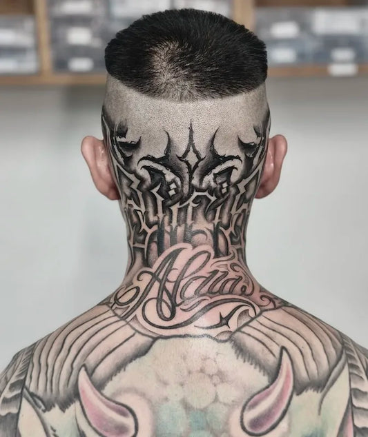 black bold lettering tattoo on back of neck head