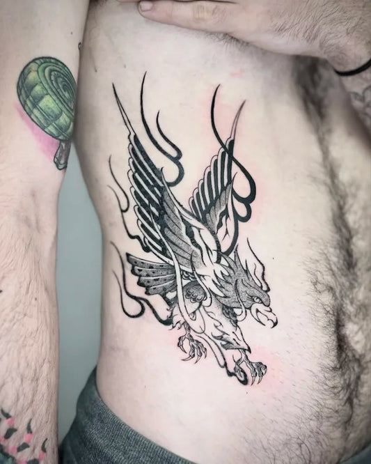 blackwork eagle black and grey tattoo on man rib