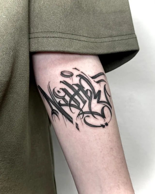 NIHIL graffiti font lettering black tattoo on arm