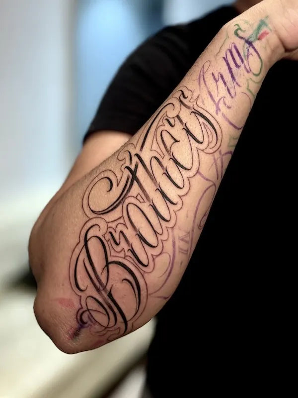 chicano font lettering in progress forearm tattoo