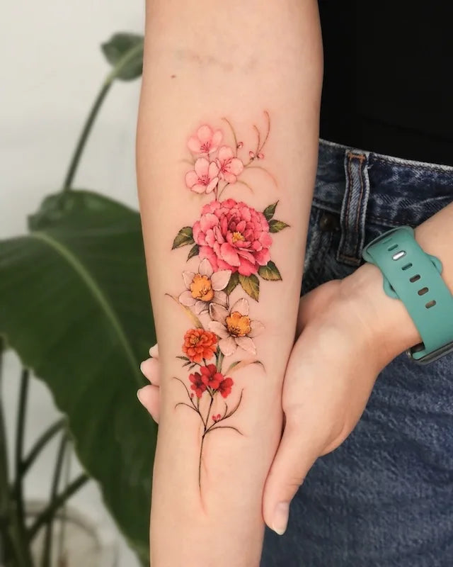 colorful realistic floral tattoo on forearm