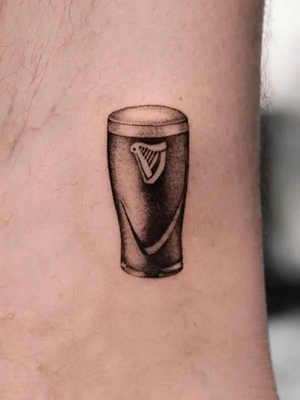 black and grey realism guinness black beer tattoo