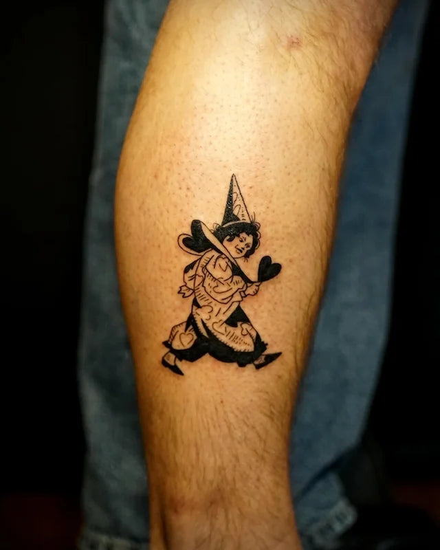 black and white wizard clown illustrative tattoo on man forearm