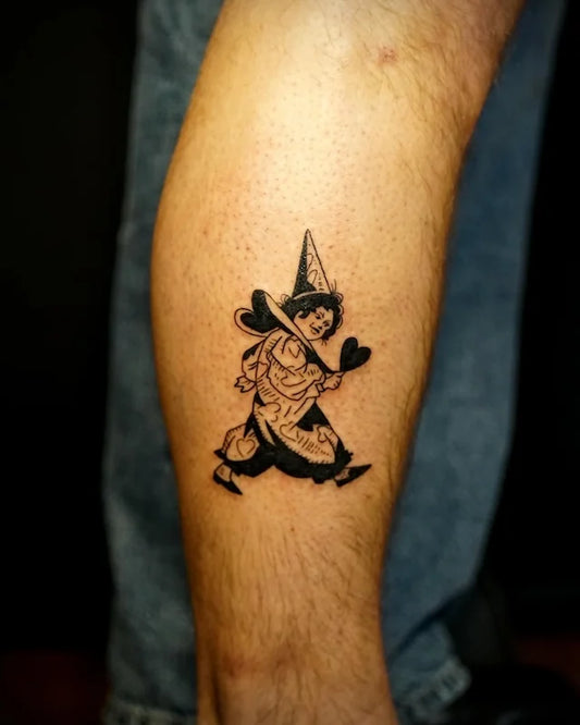 black and white wizard clown illustrative tattoo on man forearm