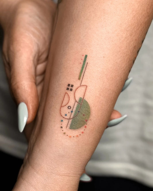 Bang Bang Basil color geometric abstract tattoo on woman forearm