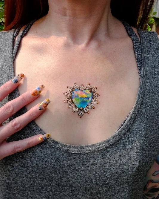 realistic colorful rainbow heart-shape gemstone color realism tattoo on woman chest