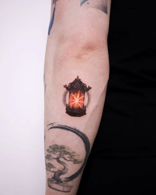 realistic glowing lantern color realism tattoo on back of arm