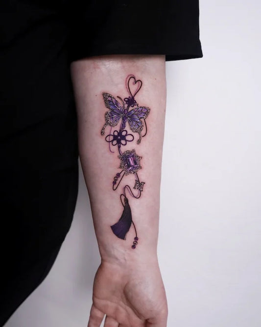 purple gemstone and butterfly knot color realism tattoo