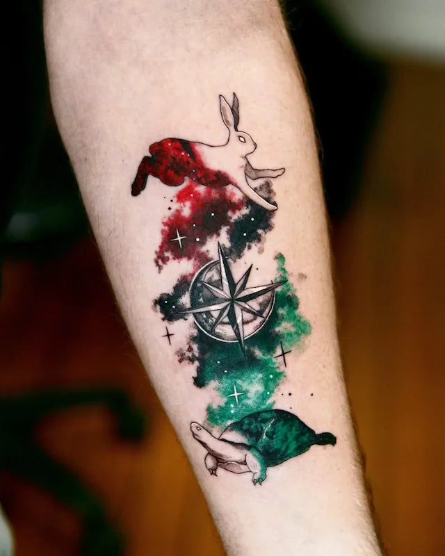 rabbit turtle and compass red green color realism tattoo on forearm