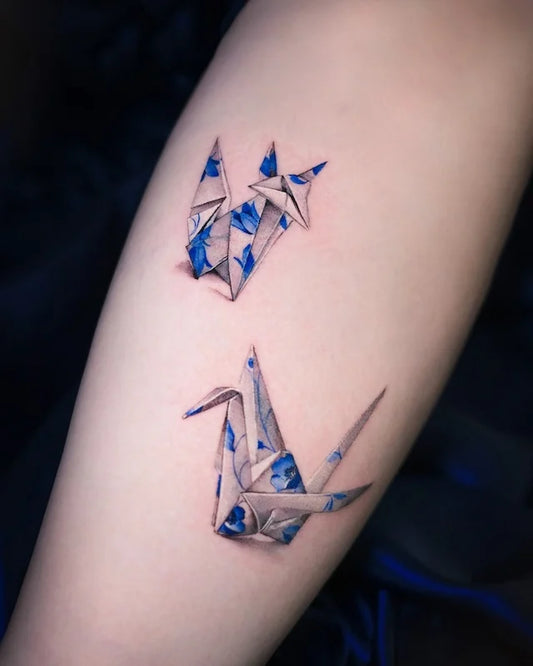 blue ceramic porcelain paper crane and fox tattoo on arm