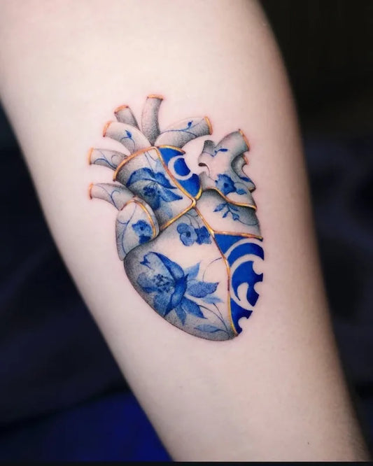 blue gold ceramic porcelain anatomical heart tattoo on arm
