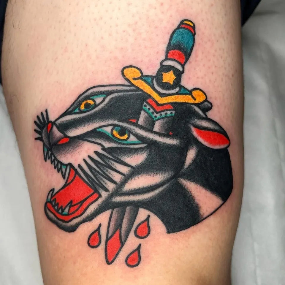 american traditional panther with dagger tattoo