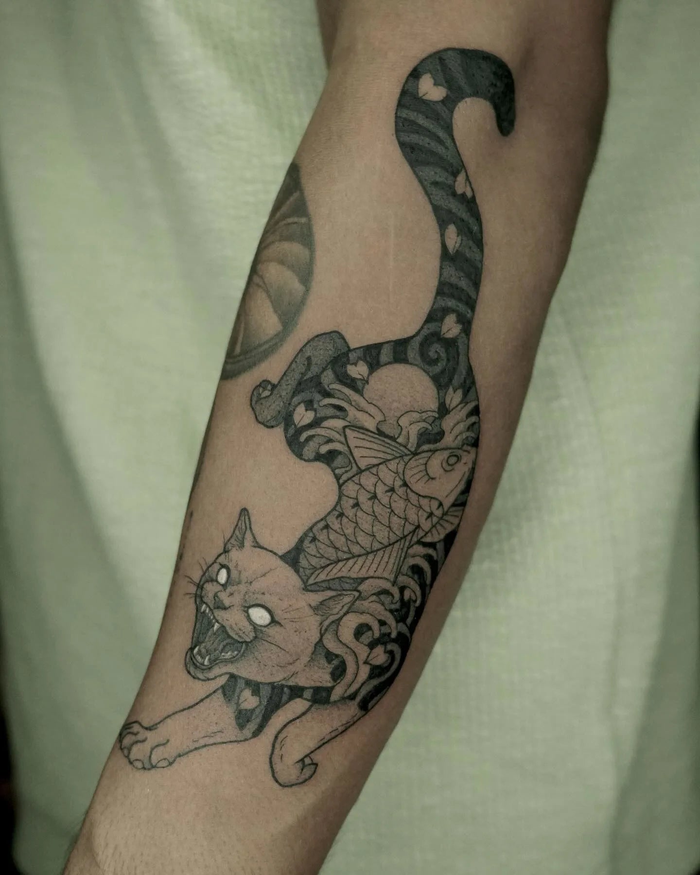dotwork evil cat tattoo on forearm