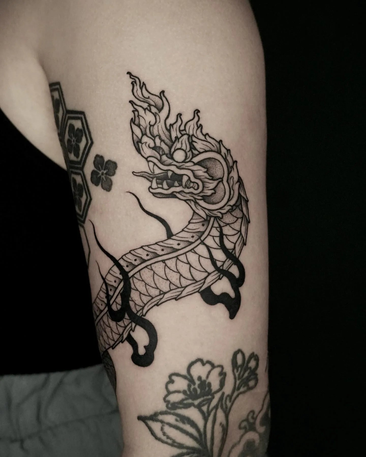 dotwork thai dragon outline tattoo on upper arm
