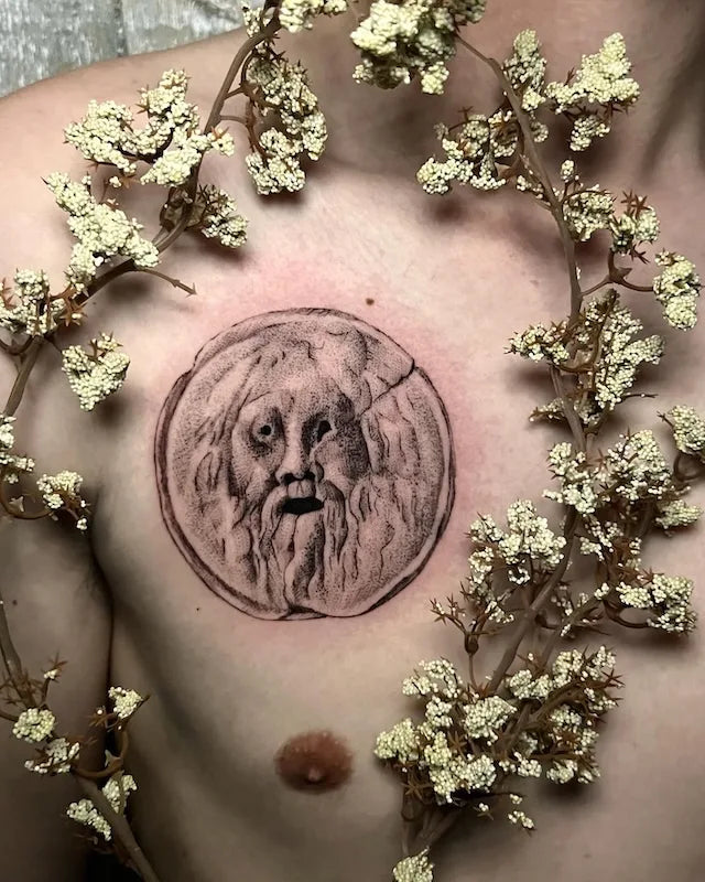 black and grey dotwork Mouth of Truth tattoo on man chest
