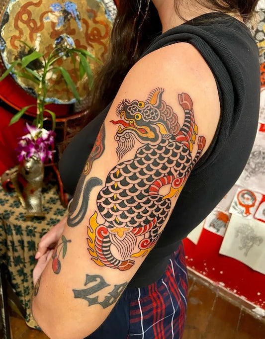 traditional thai lion singha tattoo on upper arm